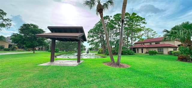 surrounding community with a lawn and a gazebo