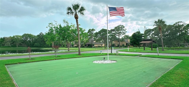 view of home's community featuring a water view and a lawn