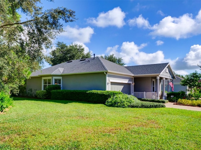 ranch-style house with a front lawn, an attached garage, and stucco siding