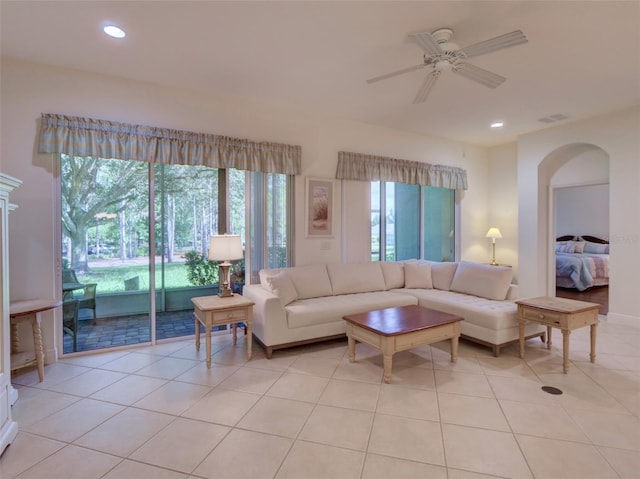 tiled living room featuring plenty of natural light and ceiling fan