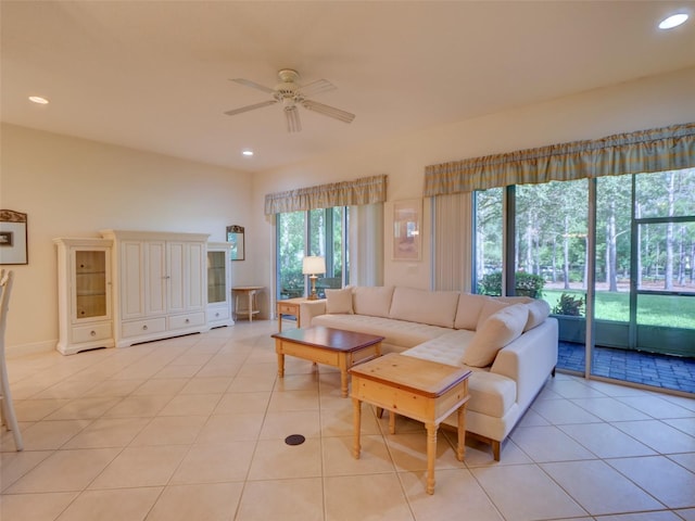 living room with ceiling fan, light tile patterned floors, and a healthy amount of sunlight