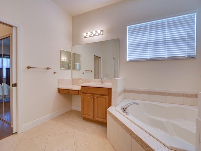 full bath featuring tile patterned flooring, baseboards, vanity, and a garden tub