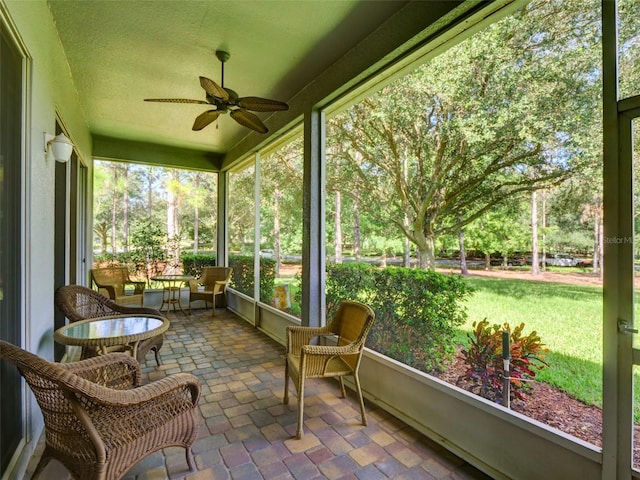 sunroom with a ceiling fan