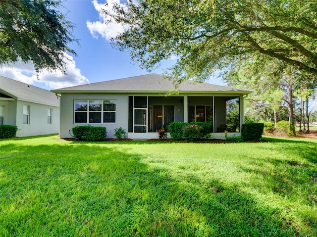 view of front of house with a sunroom and a front lawn