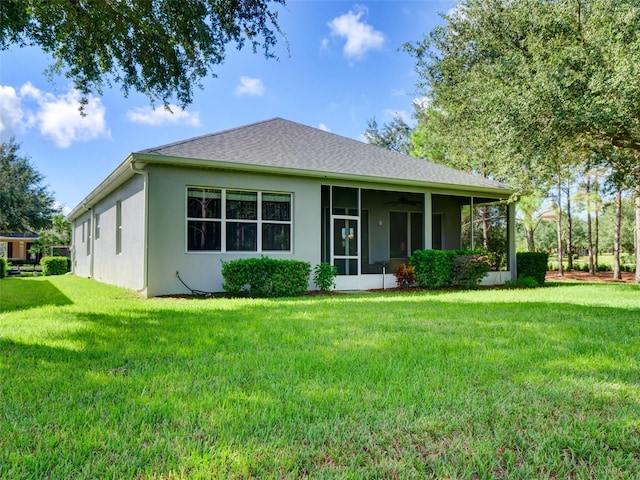 view of front of home with a front yard and a sunroom