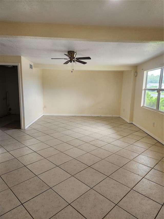 tiled empty room with ceiling fan