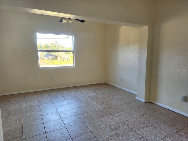 spare room with light tile patterned floors and ceiling fan