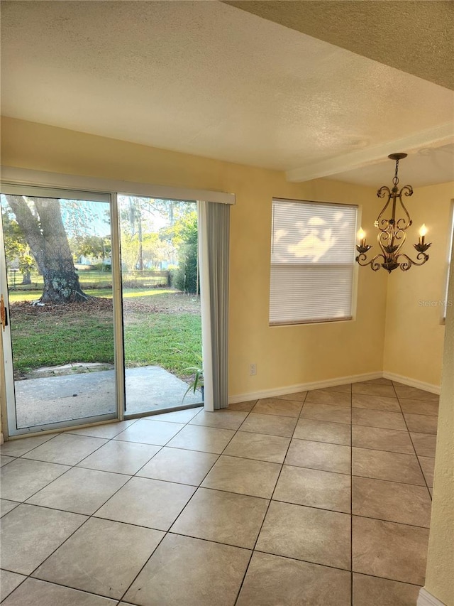 unfurnished dining area with light tile patterned floors, a textured ceiling, and a notable chandelier