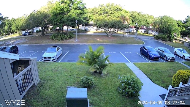 view of car parking with a lawn