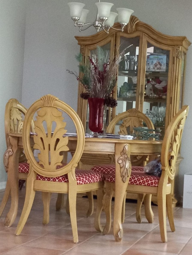 tiled dining area featuring a notable chandelier