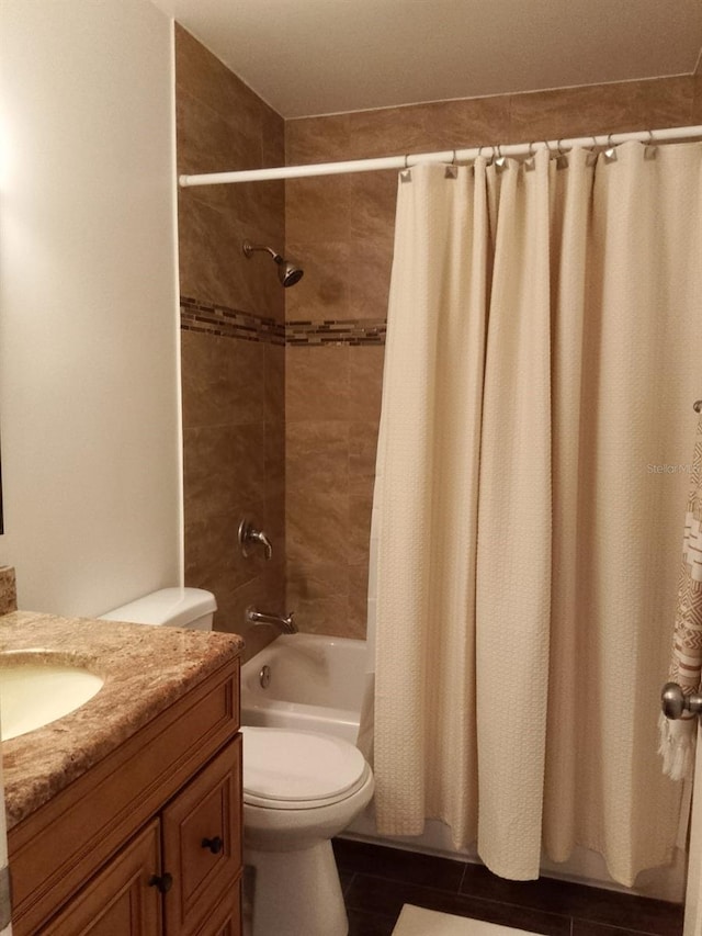 full bathroom featuring tile patterned floors, vanity, toilet, and shower / tub combo with curtain