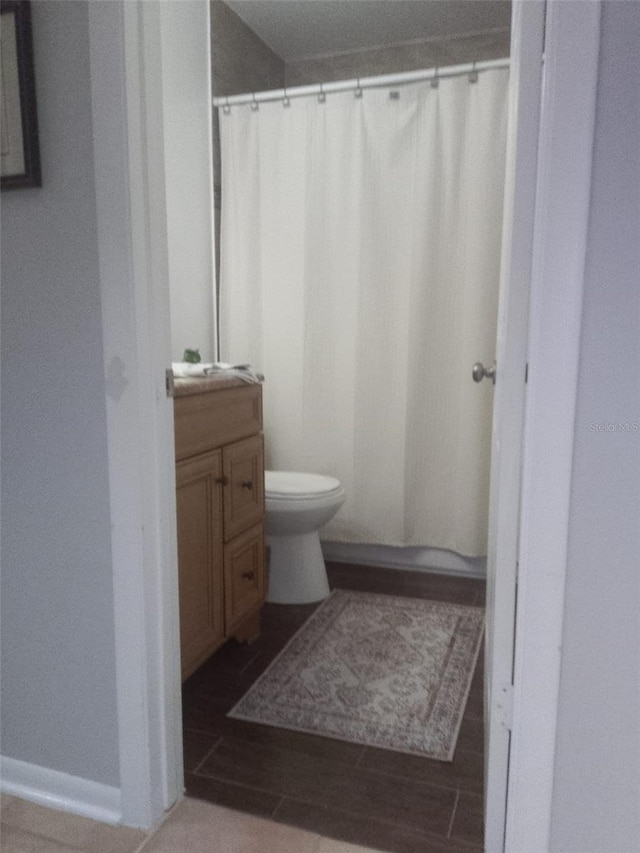 bathroom with hardwood / wood-style floors, vanity, and toilet