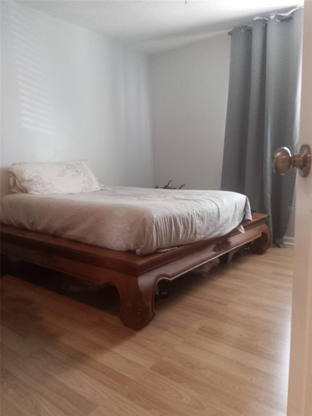 bedroom with light wood-type flooring