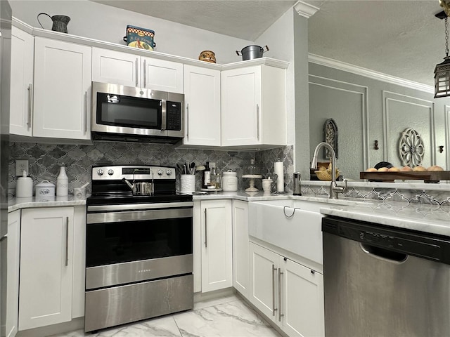 kitchen featuring decorative backsplash, stainless steel appliances, and white cabinets