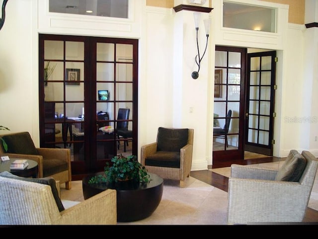 tiled living room featuring french doors