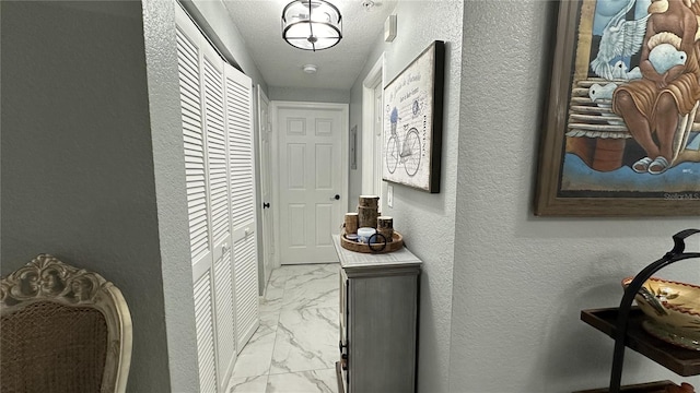 hallway with a textured ceiling