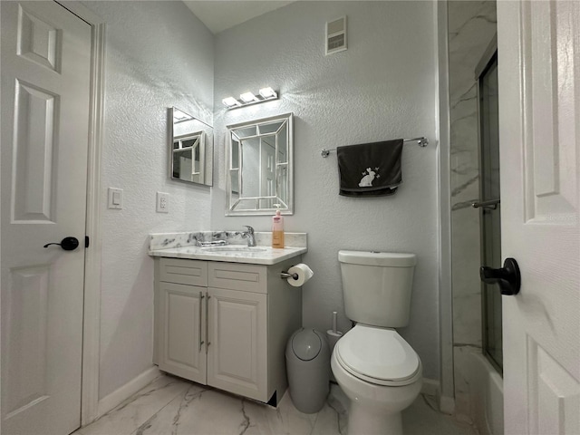 full bathroom featuring enclosed tub / shower combo, vanity, and toilet