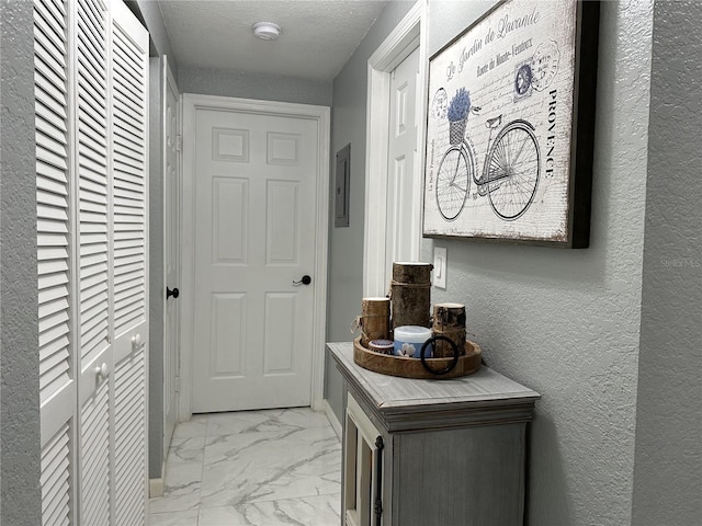 entryway with a textured ceiling and electric panel