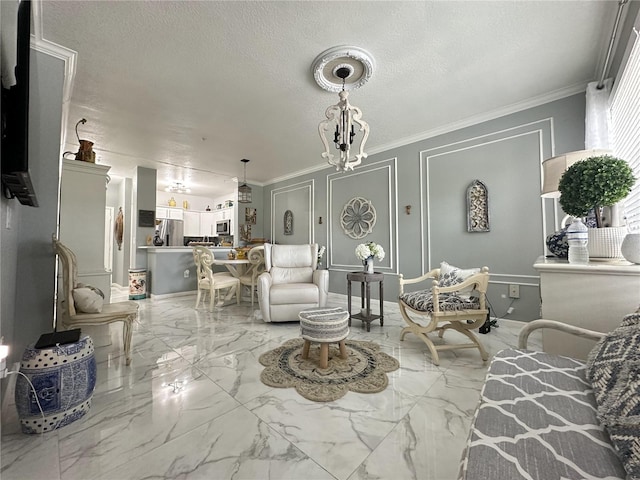 living room with a chandelier, a textured ceiling, and crown molding