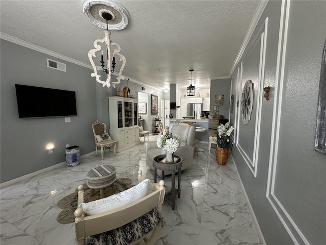 dining room with a textured ceiling, ornamental molding, and an inviting chandelier