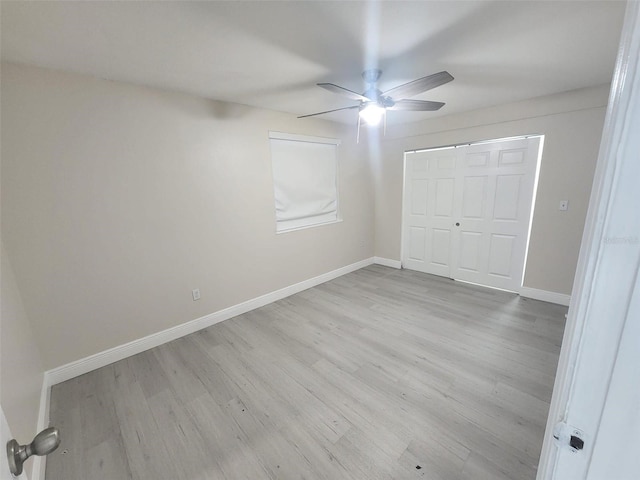 unfurnished bedroom with light wood-type flooring, a closet, and ceiling fan