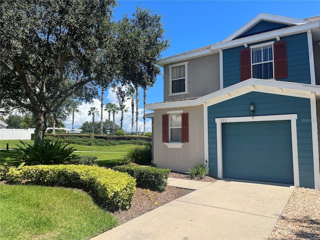 view of front facade with a garage and a front lawn