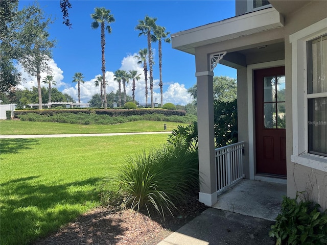 view of exterior entry featuring a yard