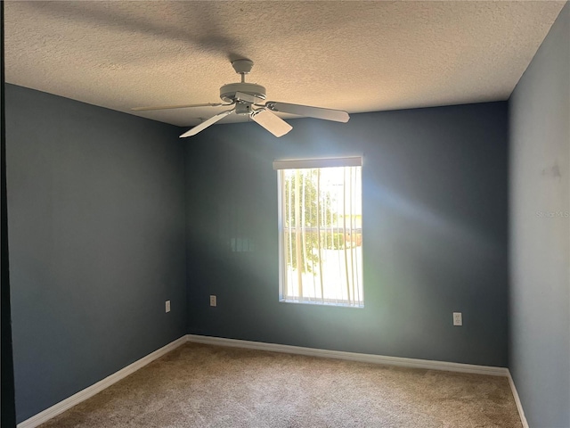 carpeted spare room featuring a textured ceiling and ceiling fan