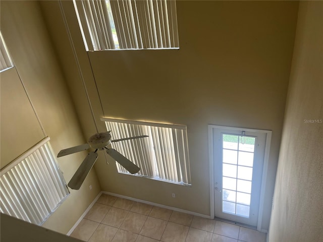 interior space with ceiling fan and light tile patterned floors