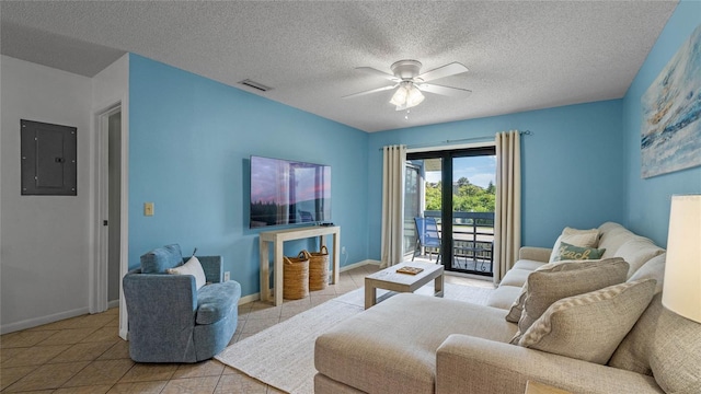 tiled living room with electric panel, ceiling fan, and a textured ceiling