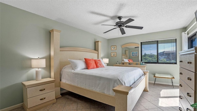 tiled bedroom featuring a textured ceiling and ceiling fan