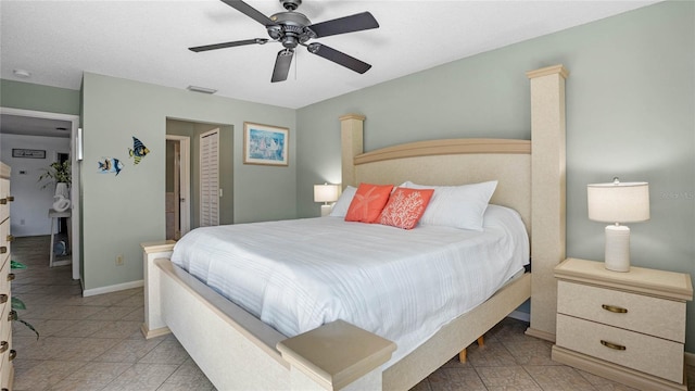 tiled bedroom featuring ceiling fan