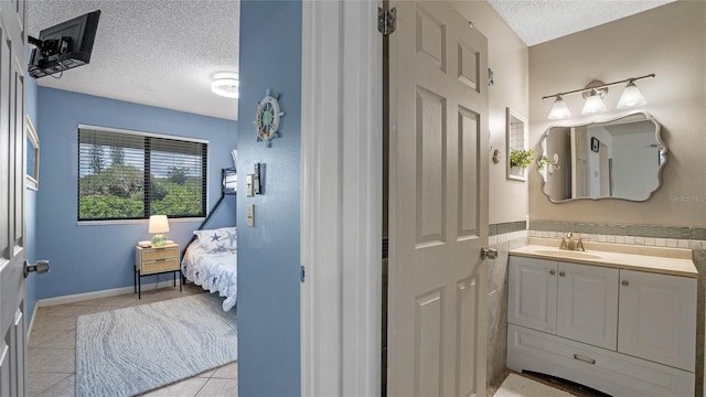 bathroom featuring tile patterned floors, a textured ceiling, and vanity