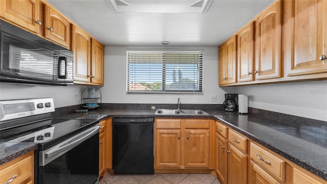 kitchen featuring black appliances, dark stone countertops, sink, and light tile patterned floors