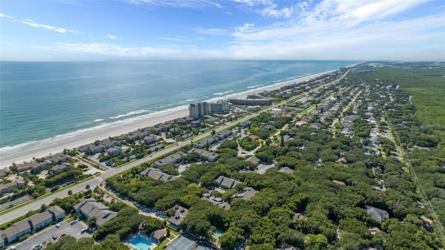 bird's eye view with a water view and a beach view