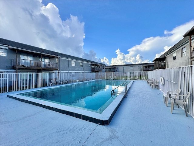 view of swimming pool with fence