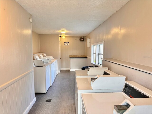 clothes washing area featuring a textured ceiling and washer and dryer