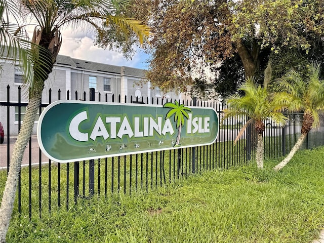 community sign with a yard and fence