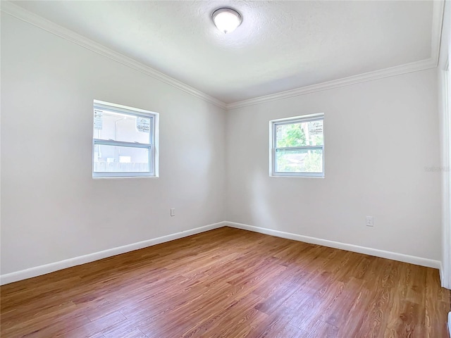 unfurnished room featuring crown molding and wood-type flooring