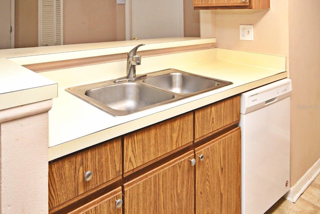 kitchen with dishwasher, sink, and light tile patterned flooring