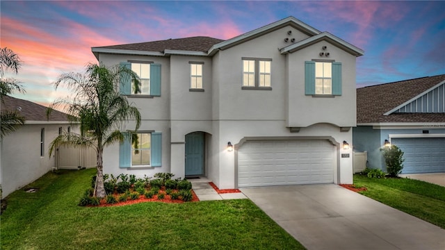 view of front of home featuring a garage and a lawn