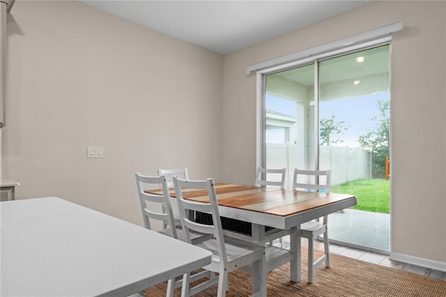 dining space featuring a healthy amount of sunlight and light tile patterned floors