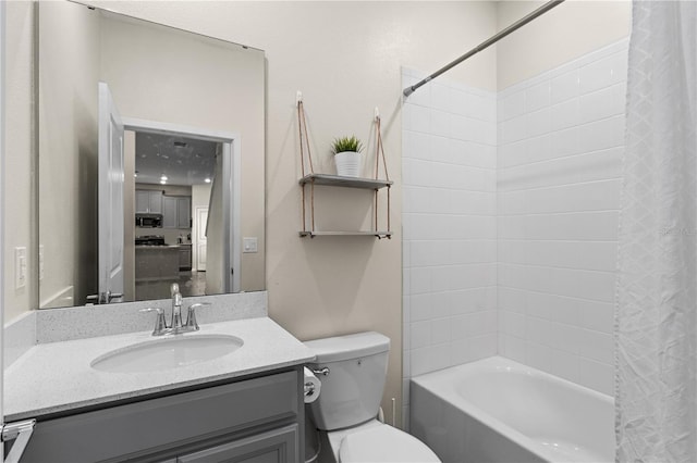 full bathroom with shower / bath combination with curtain, toilet, and vanity