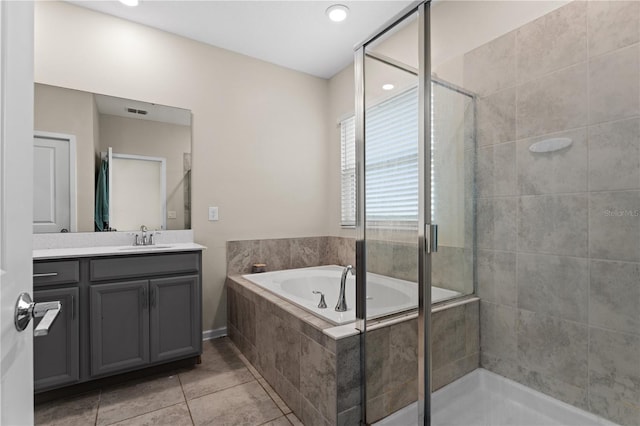 bathroom featuring tile patterned floors, separate shower and tub, and vanity