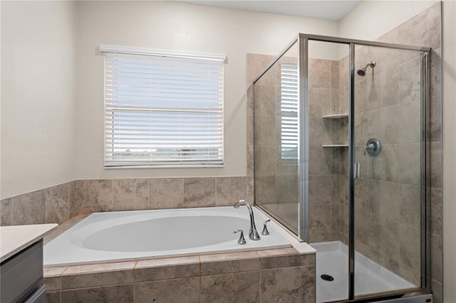 bathroom featuring plus walk in shower and vanity