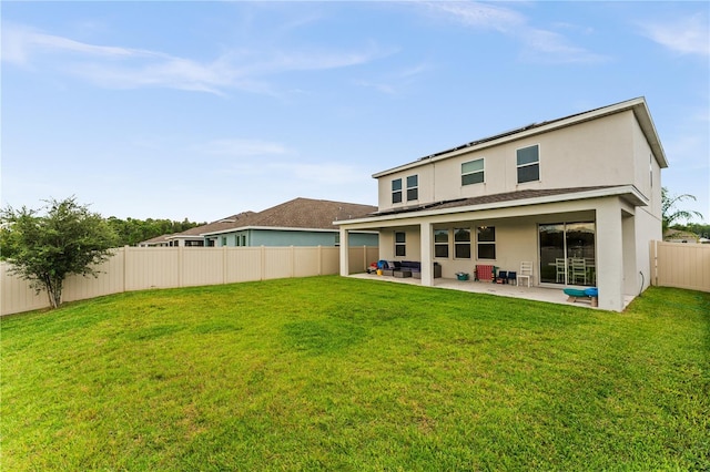 rear view of property with a patio area and a lawn