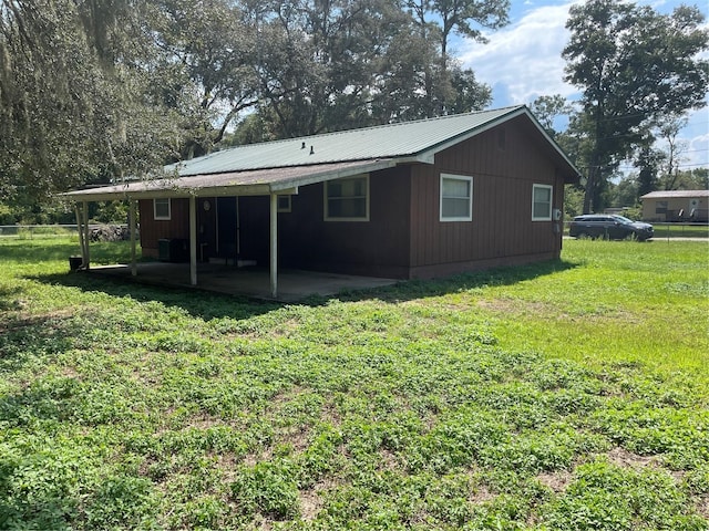 rear view of property with a lawn and a patio area