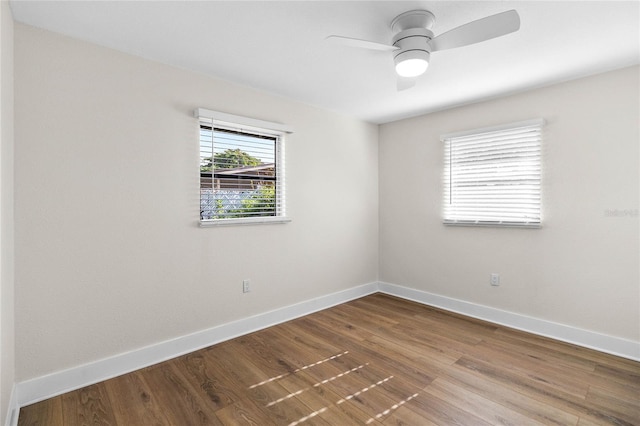 empty room with hardwood / wood-style floors and ceiling fan