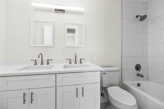 full bathroom featuring vanity, toilet, and tiled shower / bath