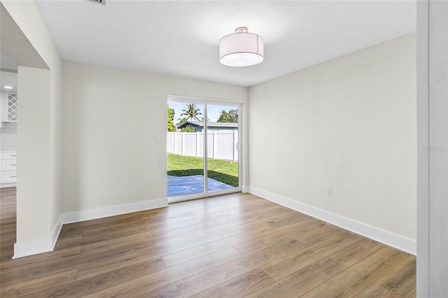 empty room with hardwood / wood-style floors